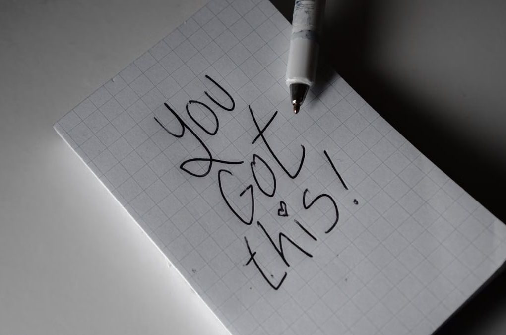 Inspirational handwritten note on graph paper with pen. Encouraging words 'You got this!'