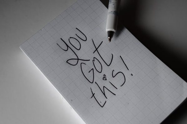 Inspirational handwritten note on graph paper with pen. Encouraging words 'You got this!'